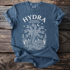 Blue t-shirt with white graphic of a multi-headed hydra serpent, stars, moon