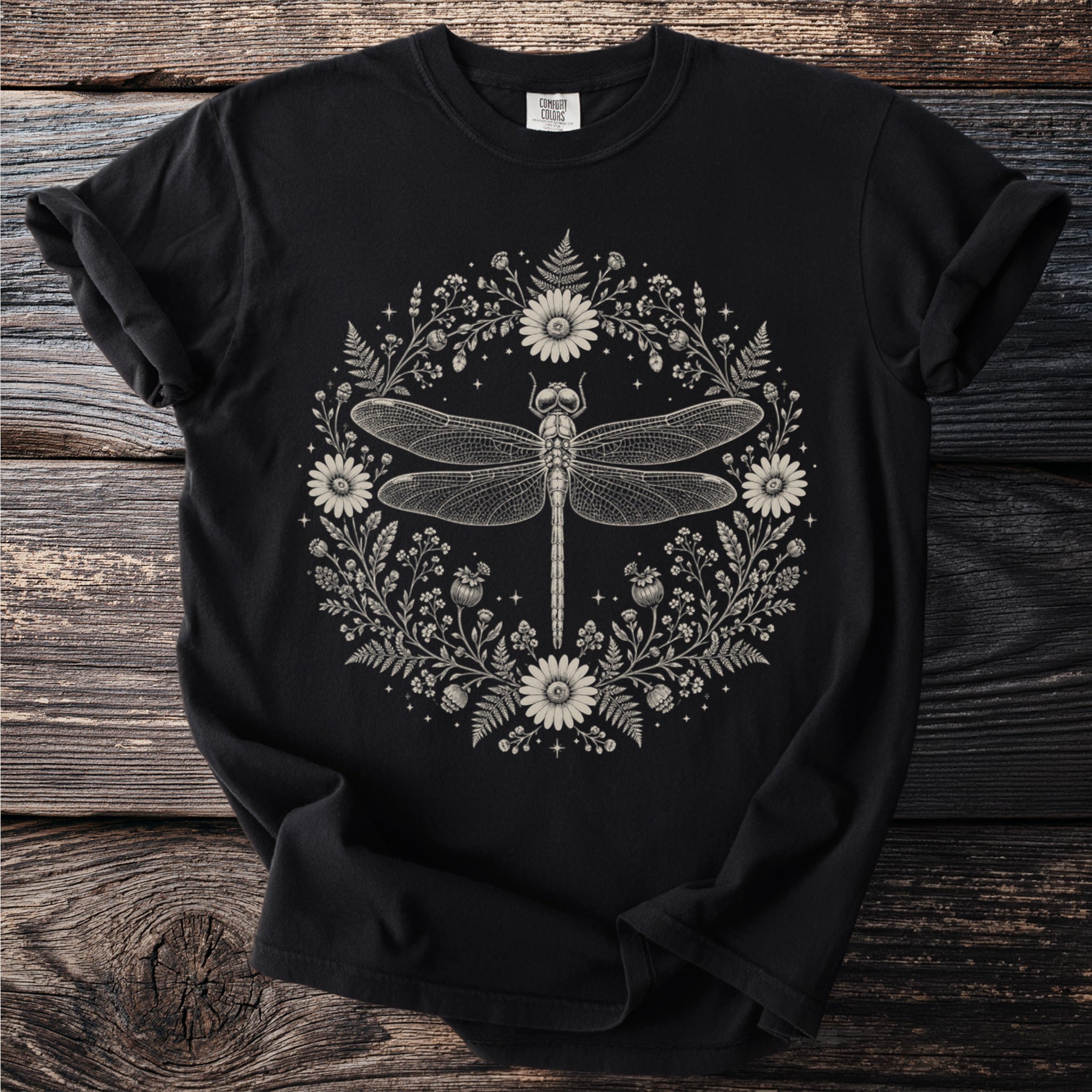 Black t-shirt with a detailed dragonfly and floral wreath illustration.
