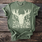 Green t-shirt with cream deer skull, antlers, and floral design.