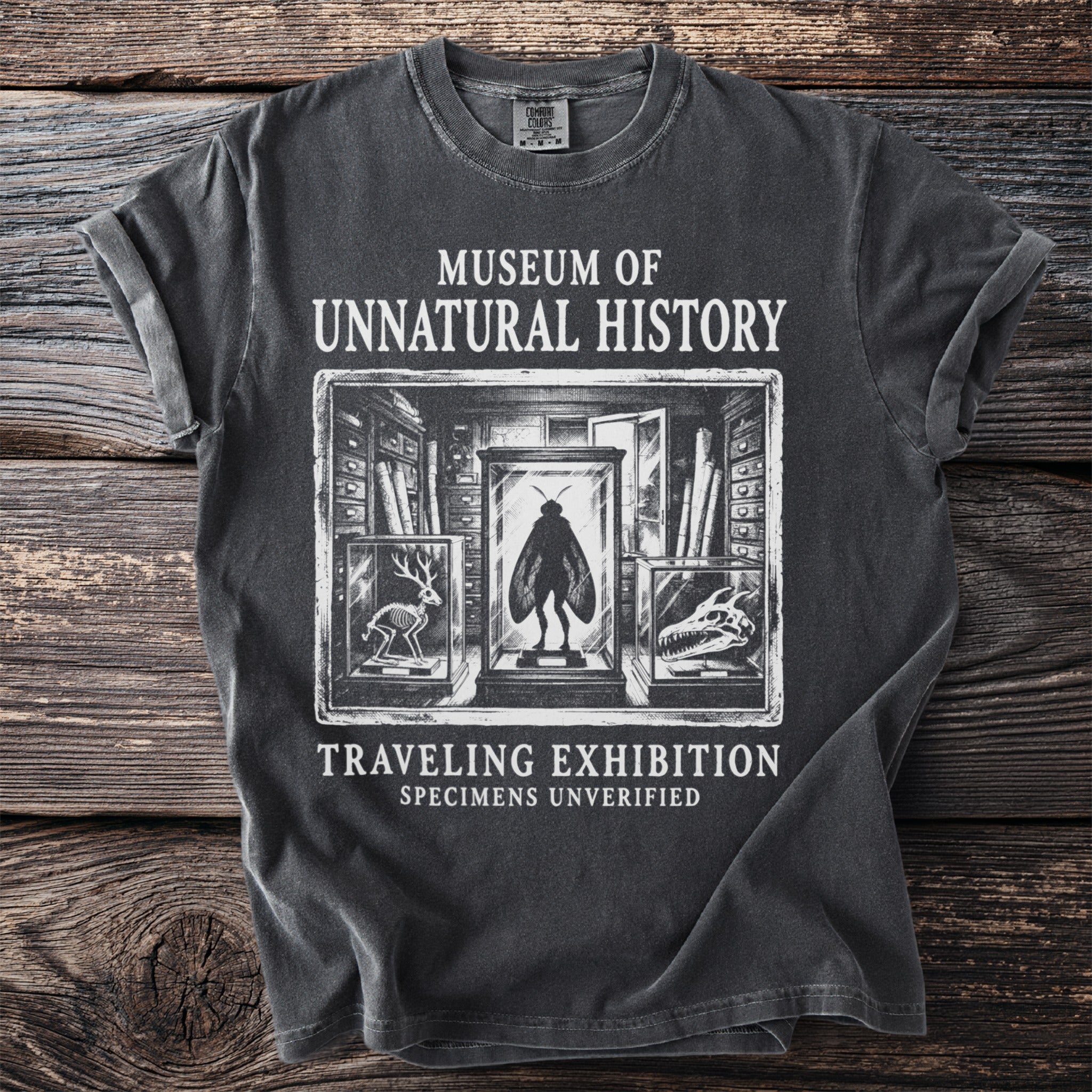 Dark t-shirt with "Museum of Unnatural History" and exhibition graphics.