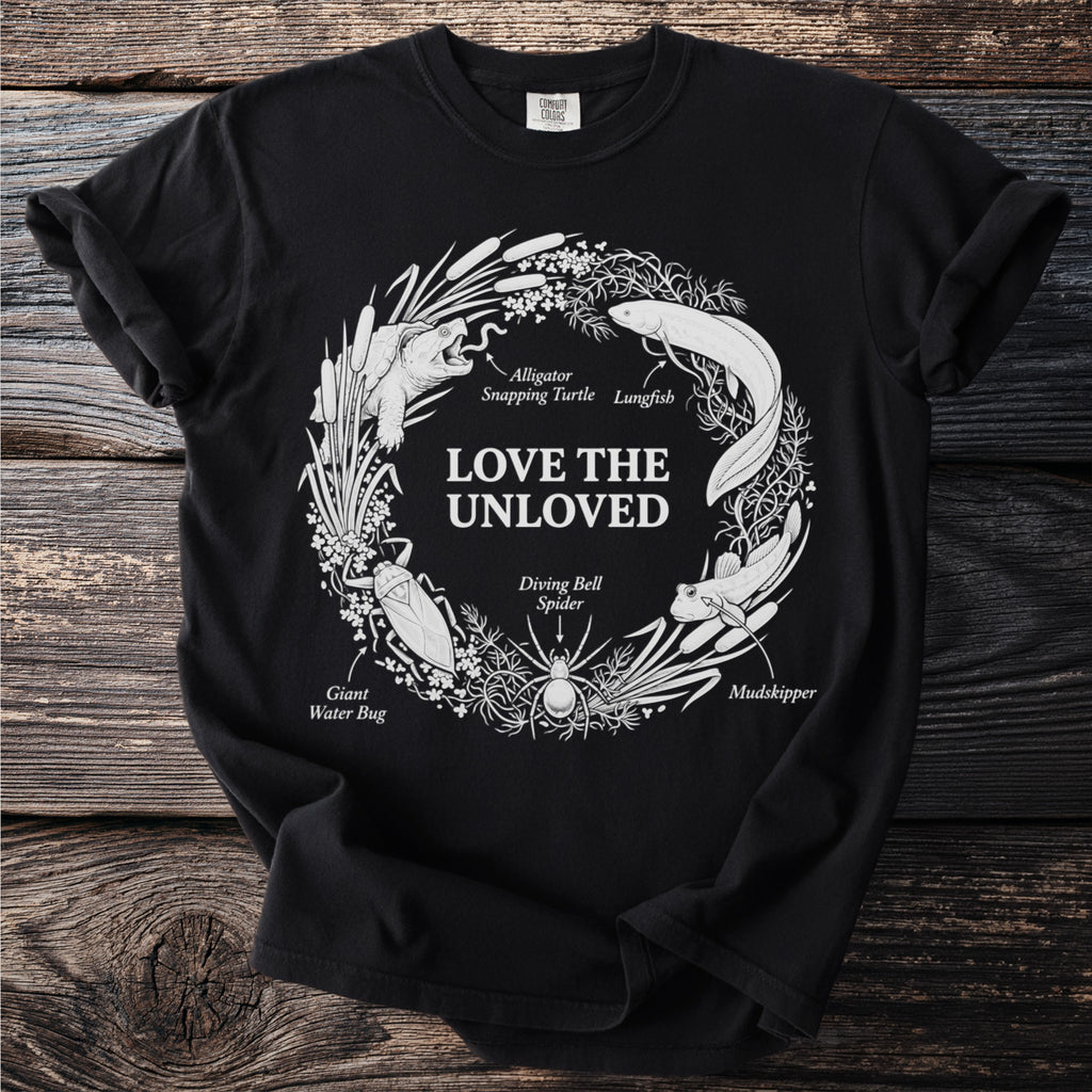 Black t-shirt with "LOVE THE UNLOVED" and illustrations of creatures.