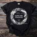 Black t-shirt with "LOVE THE UNLOVED" and illustrations of creatures.