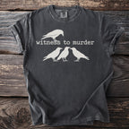 Dark grey t-shirt with white graphic of a crow and text "witness to murder".
