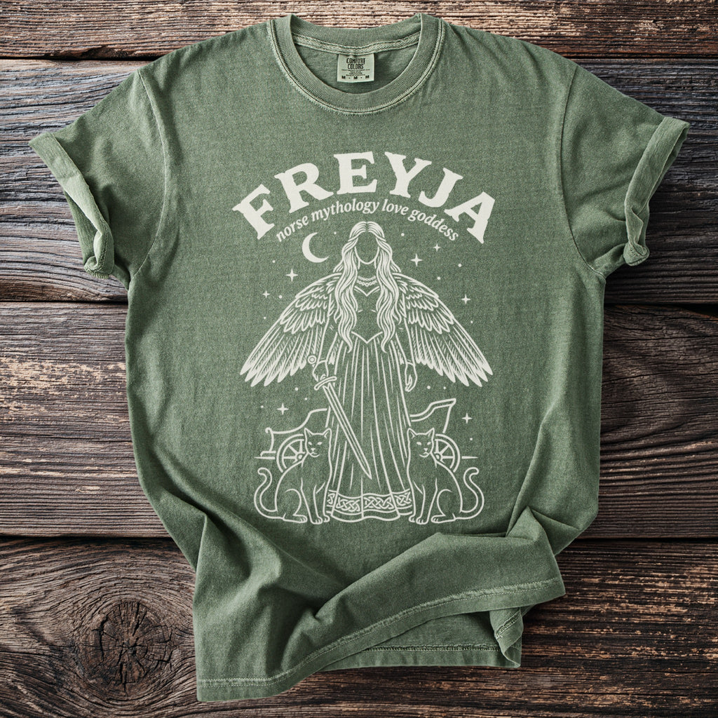 Green t-shirt with a white graphic of Freyja, Norse goddess, with cats and a chariot.