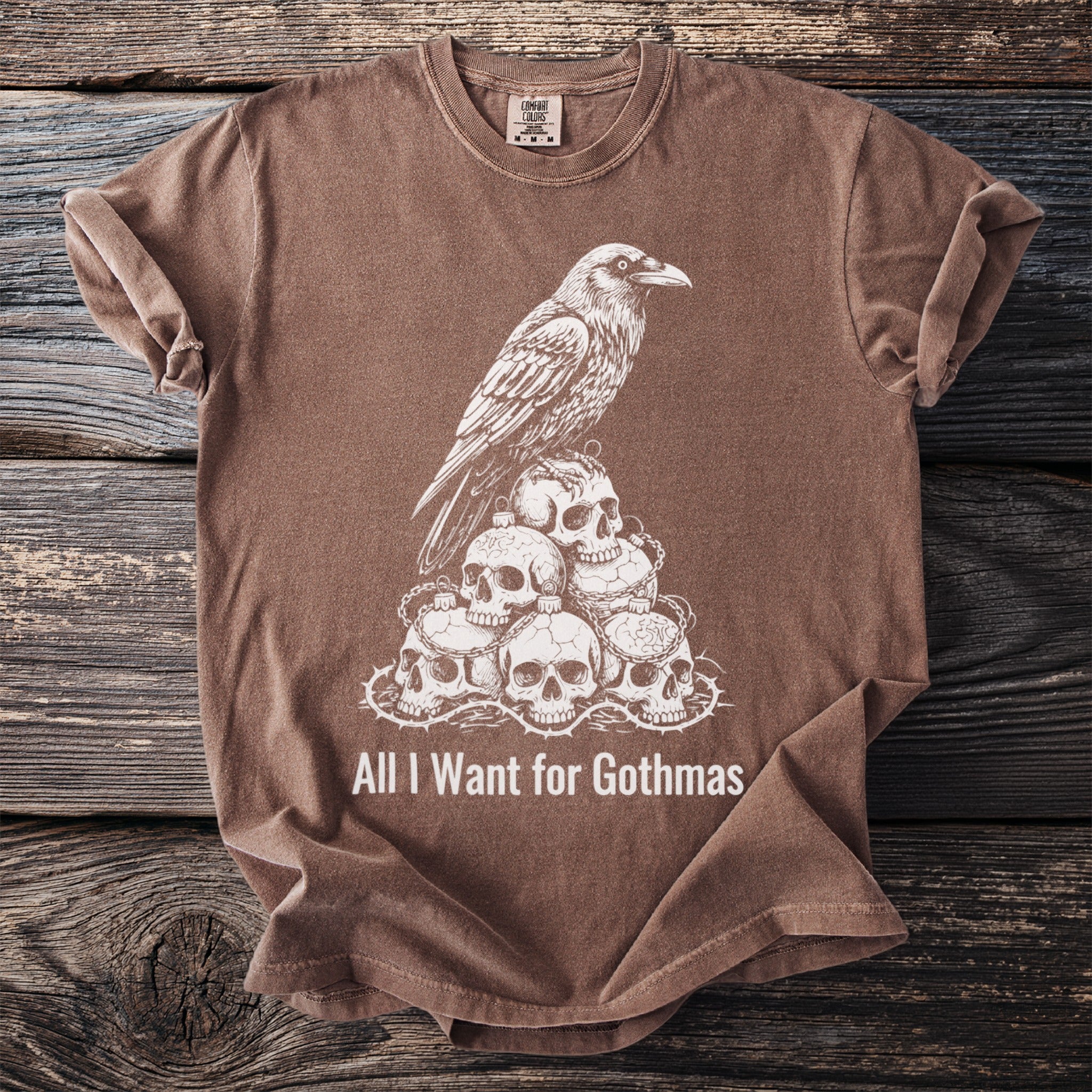 Brown t-shirt with a raven on skulls and "All I Want for Gothmas" text.