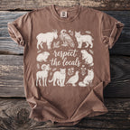 Brown t-shirt with white line art of animals and text "respect the locals".