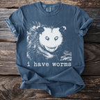 Blue t-shirt with black and white opossum graphic and text "i have worms"