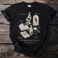 Black t-shirt with illustrated natural history items and text "The Naturalist's Table".