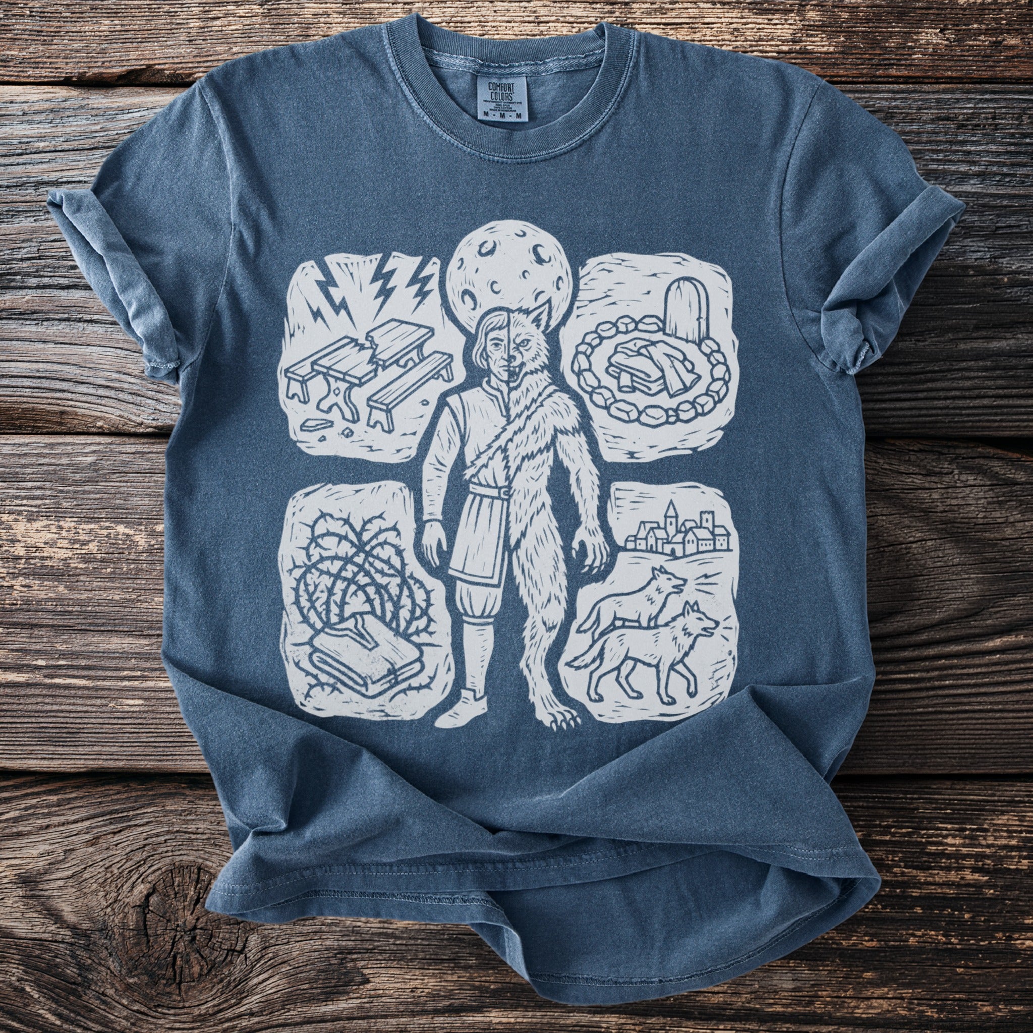 Blue t-shirt with a linocut-style graphic of a half-man, half-wolf figure.