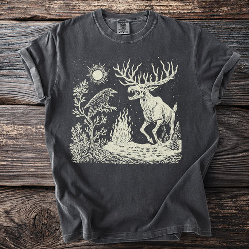 Dark grey t-shirt with cream linocut design of a raven and skeletal elk by a campfire.