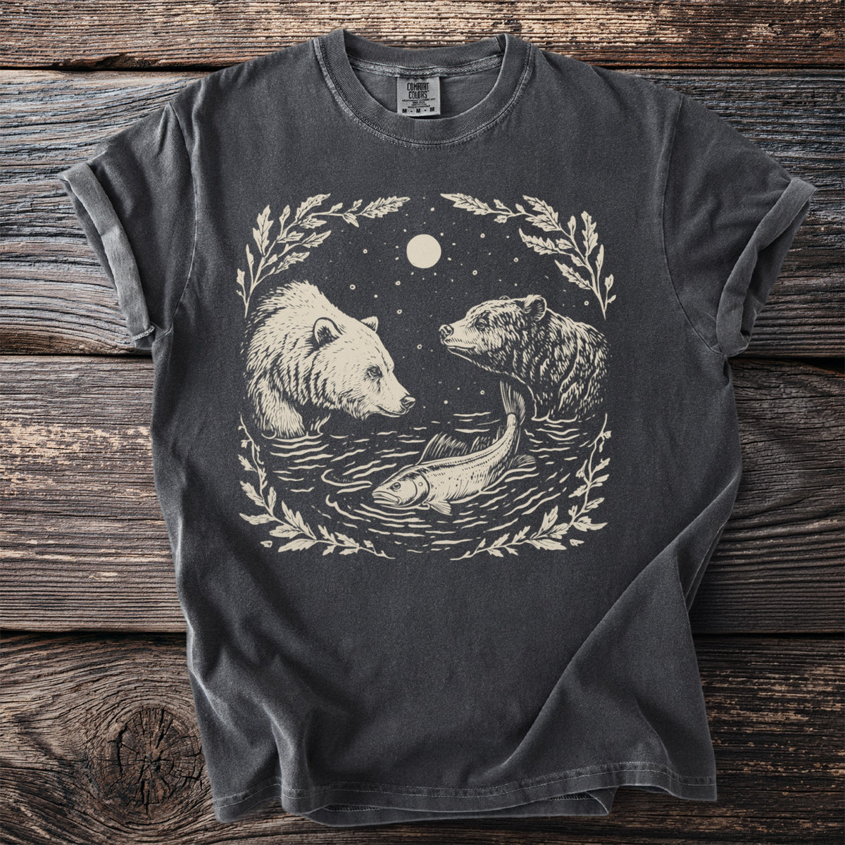 T-shirt with cream graphic of two bears and a fish in water under moon.