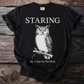 Black t-shirt with "STARING" text, an owl illustration, and "Fig. 1: Eyes Do Not Move."