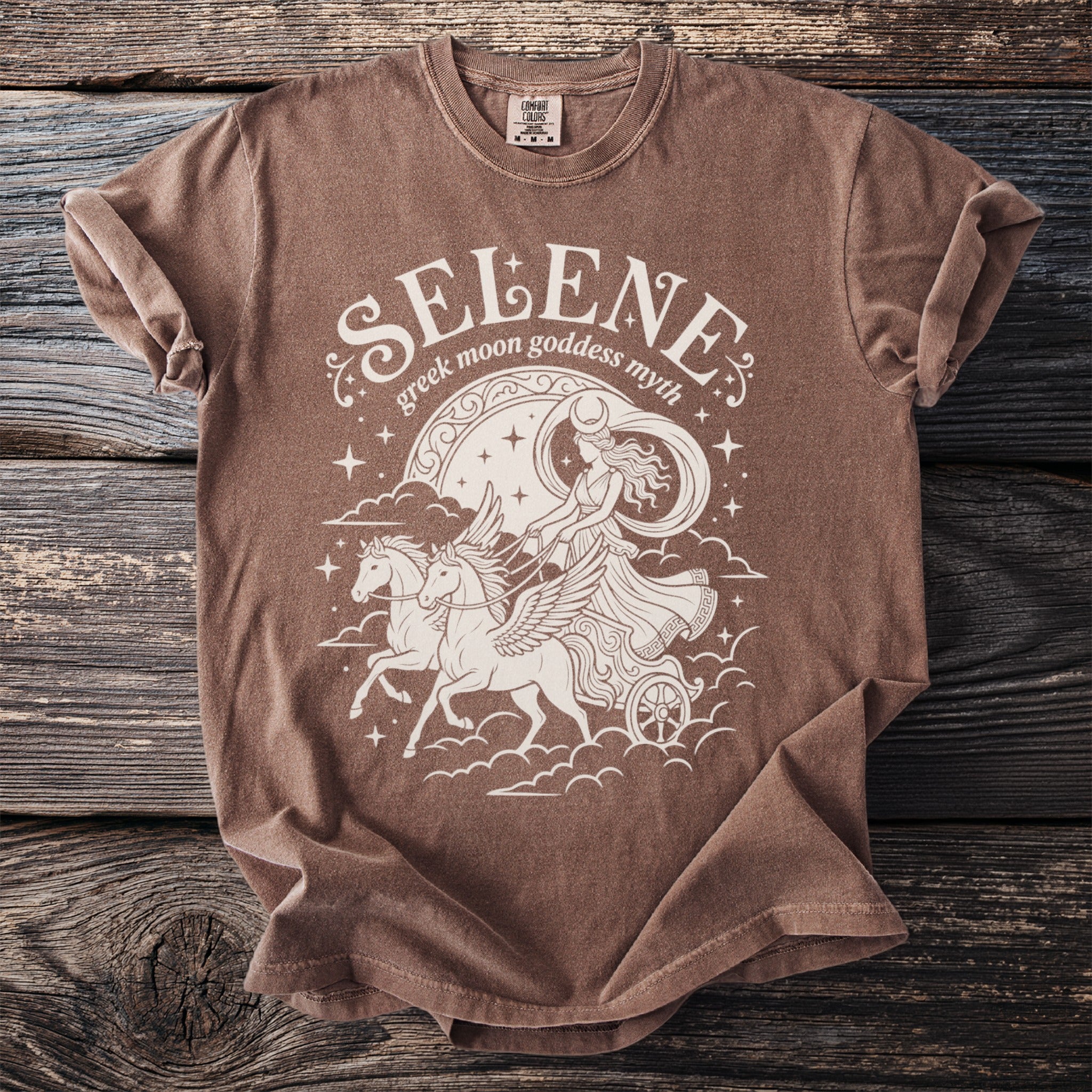 Brown t-shirt with "Selene Greek Moon Goddess Myth" graphic of a chariot pulled by winged horses.
