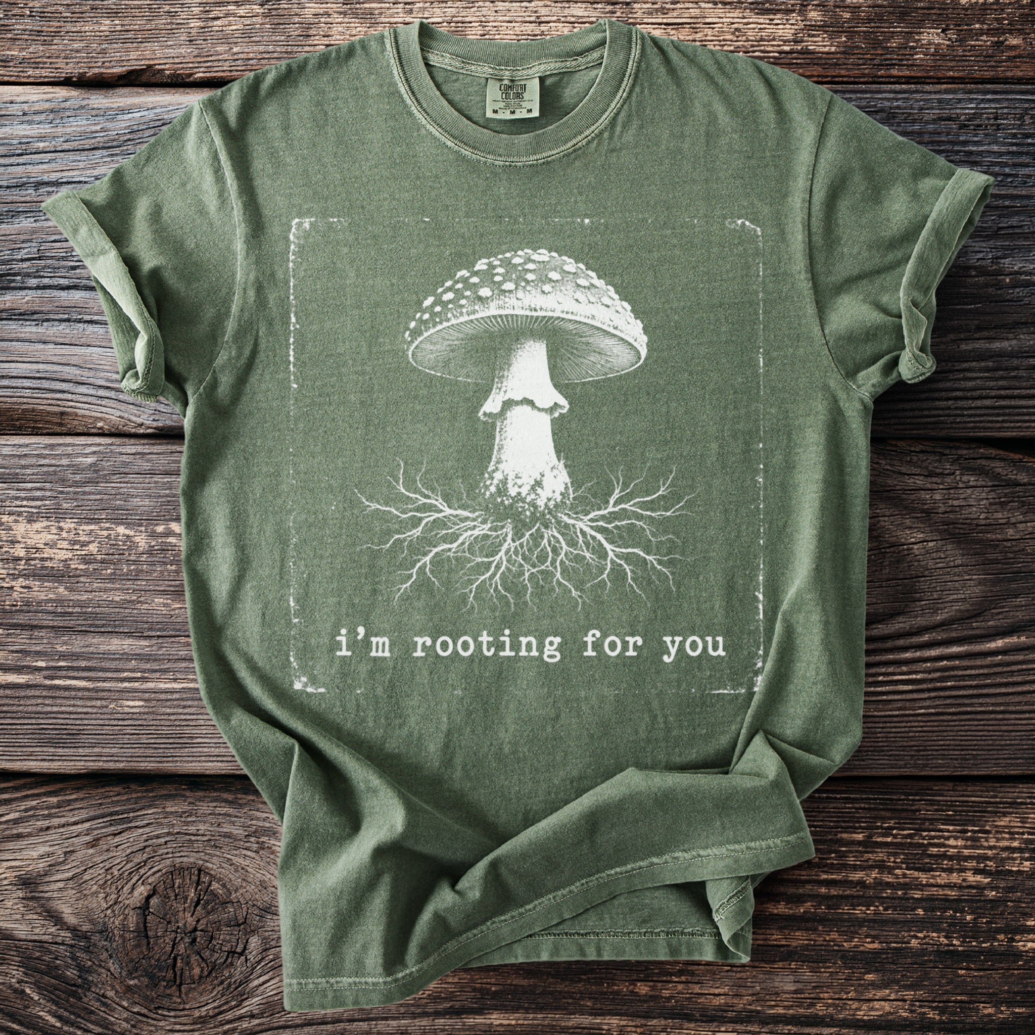 Green t-shirt with illustration of mushroom and roots, and text "i'm rooting for you".