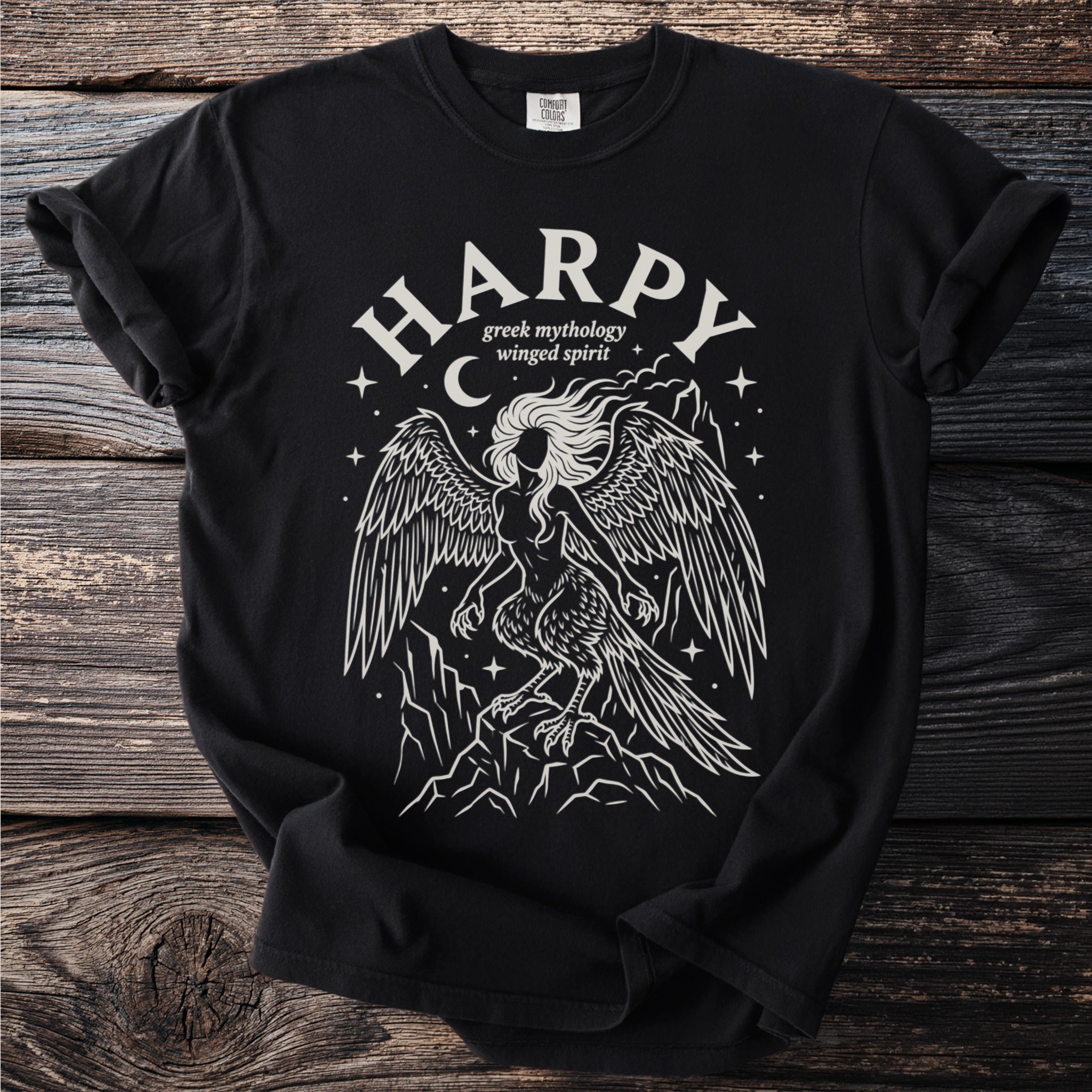 Black t-shirt with white line art of a harpy, greek mythology winged spirit.