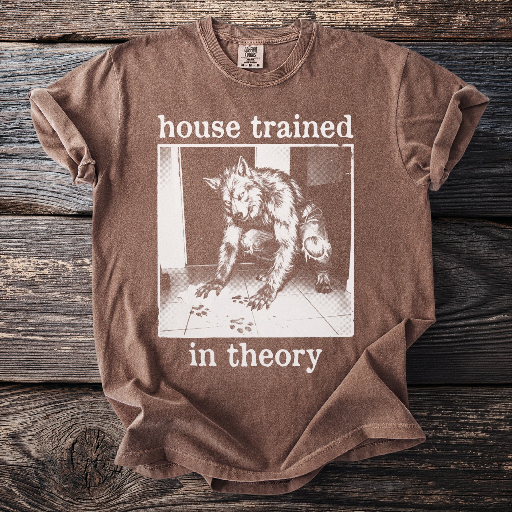 Brown t-shirt with a werewolf image and text "house trained in theory".