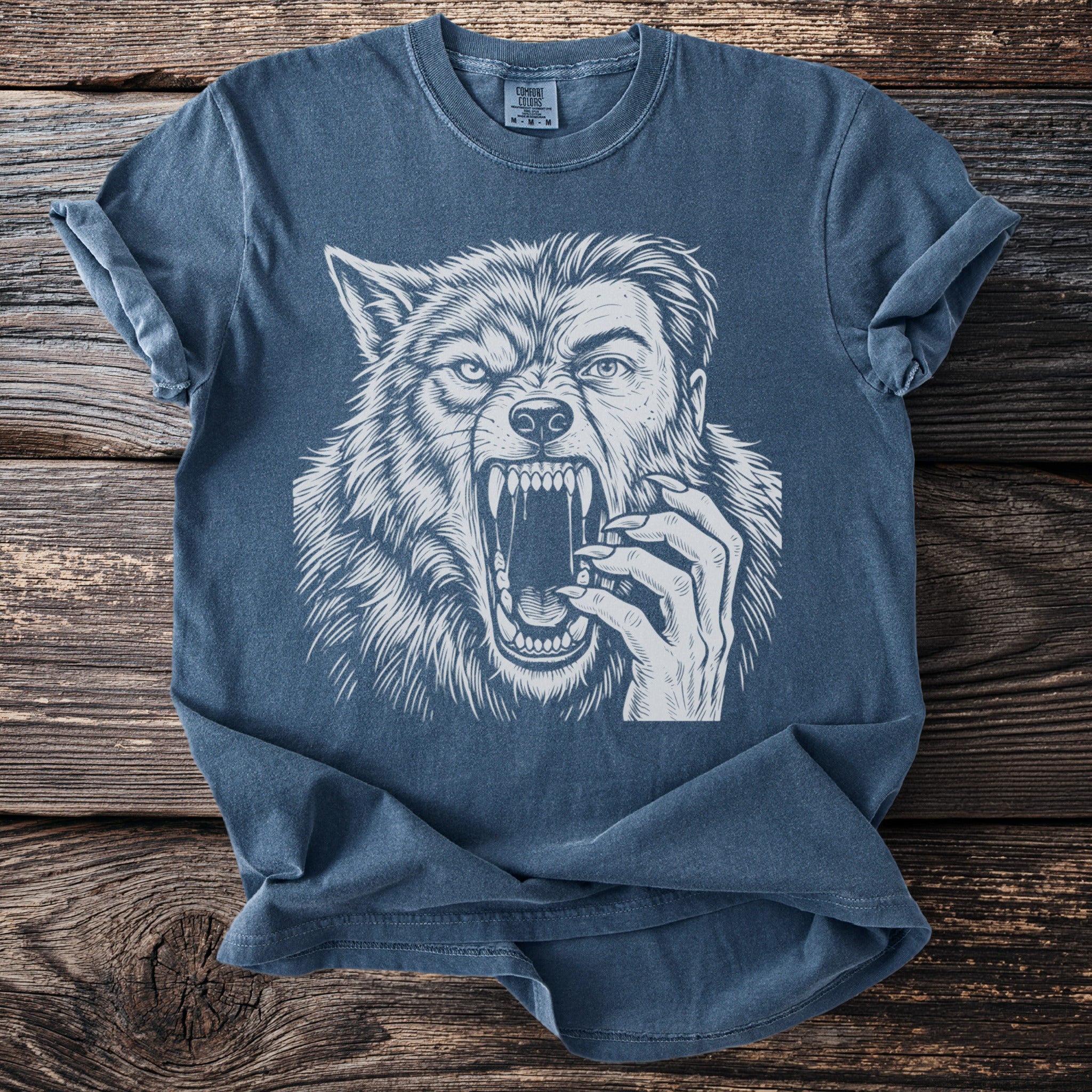 T-shirt with a white illustration of a roaring werewolf's head and a human hand.