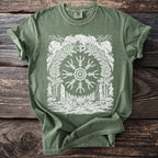 Green t-shirt with white graphic of Viking helmet, compass, trees, and axes.