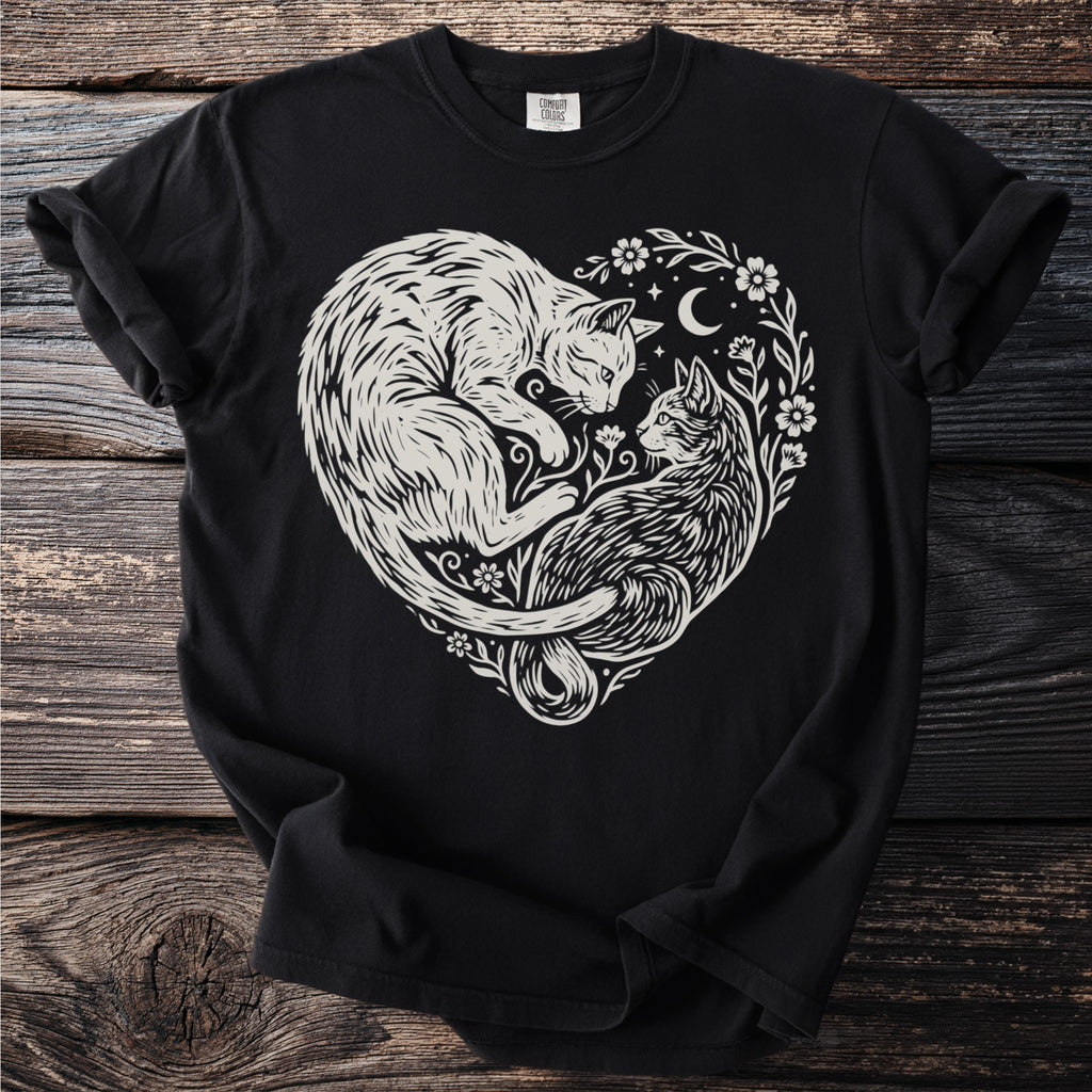 Black t-shirt featuring a white linocut design of two cats intertwined in a heart shape.