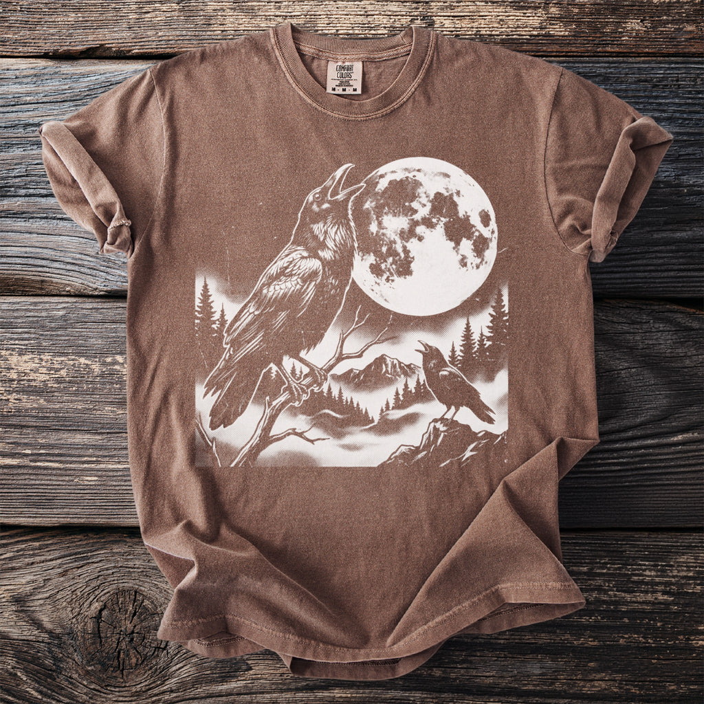 Brown t-shirt with two ravens and a large full moon in a wooded mountain landscape.