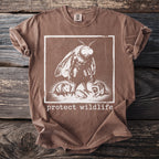 Brown t-shirt with a moth, opossum, frog, and raccoon graphic and "protect wildlife" text.