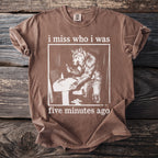 Brown t-shirt with werewolf at sink graphic and text "i miss who i was five minutes ago".