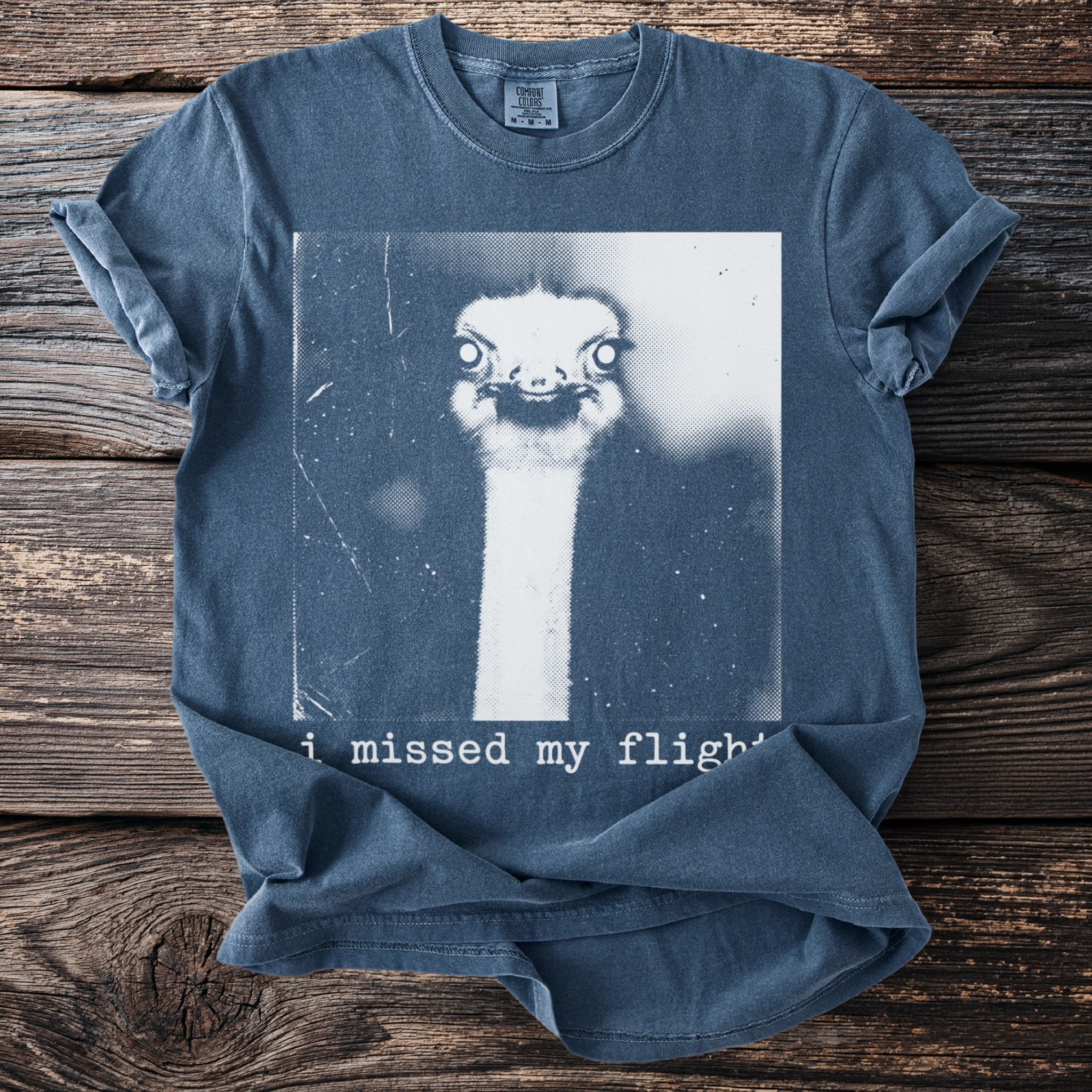 Blue t-shirt with ostrich graphic and text "i missed my flight"