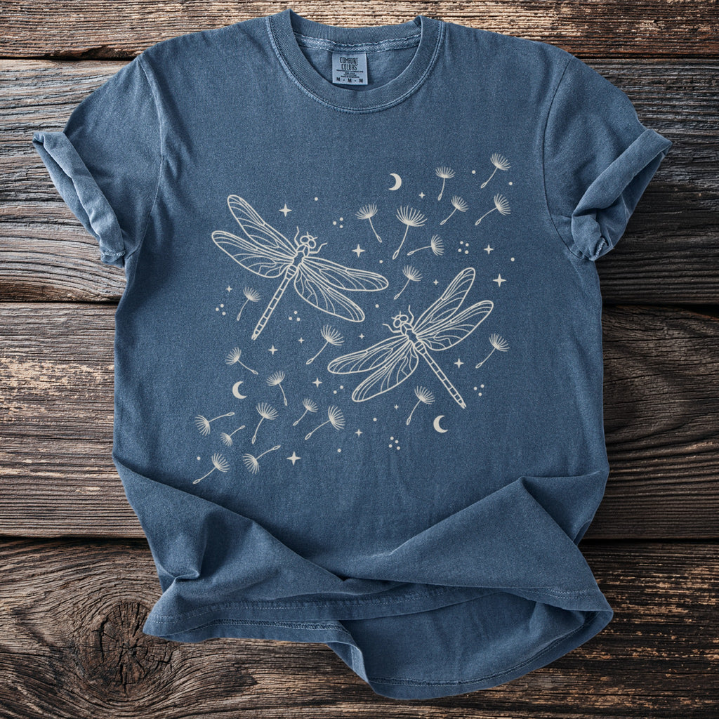 Blue t-shirt with white line drawing of two dragonflies and dandelion seeds.