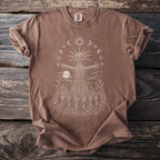 Brown t-shirt with a sun, moon cycle, and figure design.