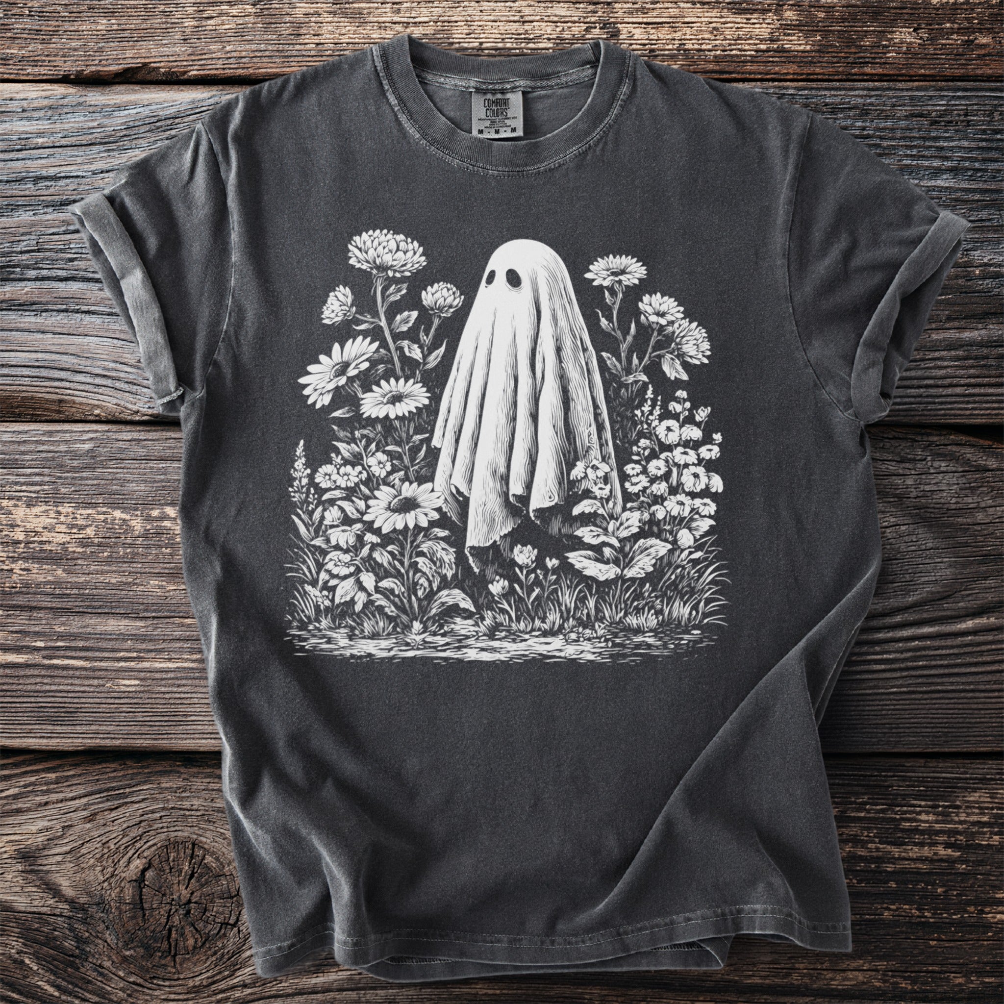 T-shirt with a white ghost and floral design on a charcoal background.