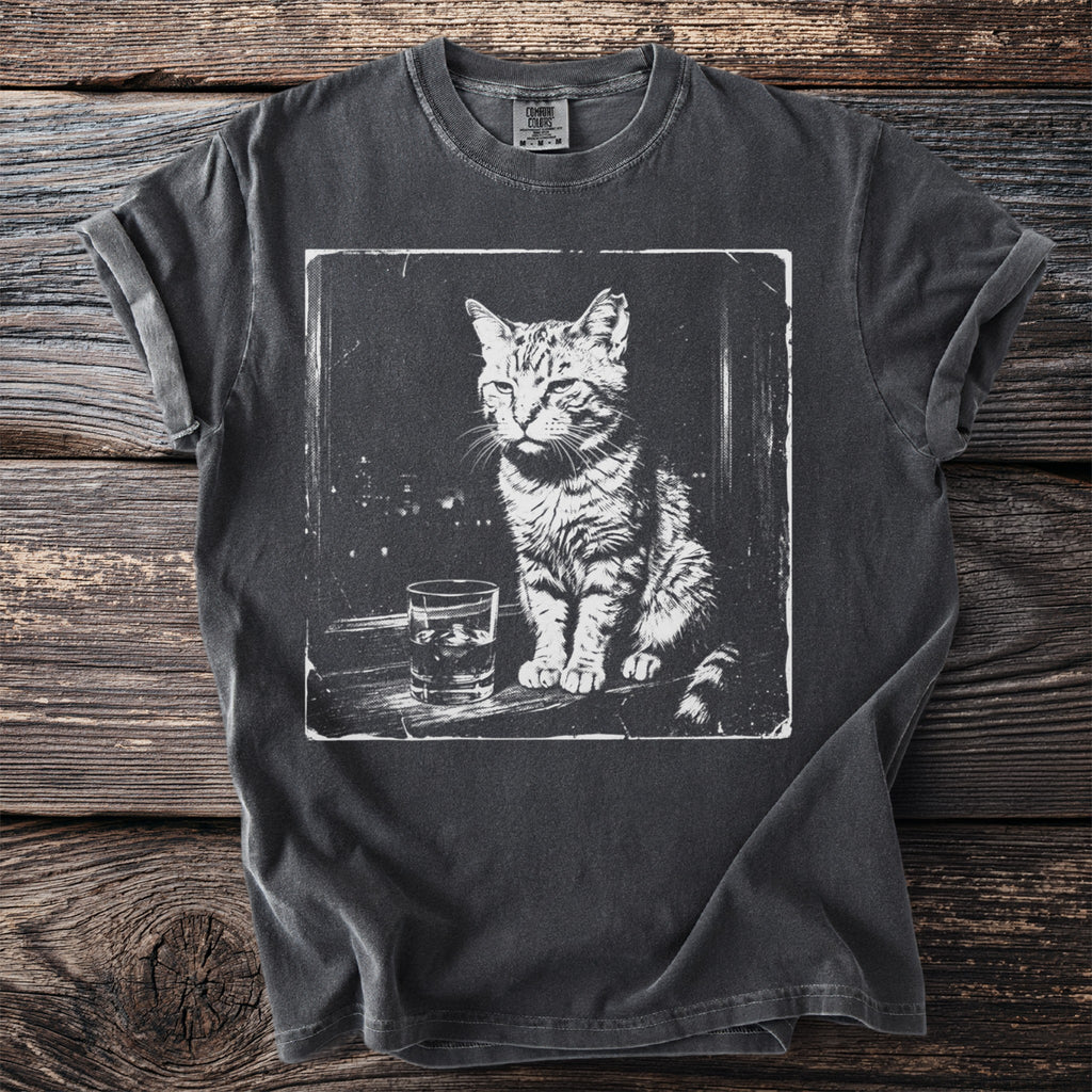 T-shirt with a black and white graphic of a cat sitting next to a drink.