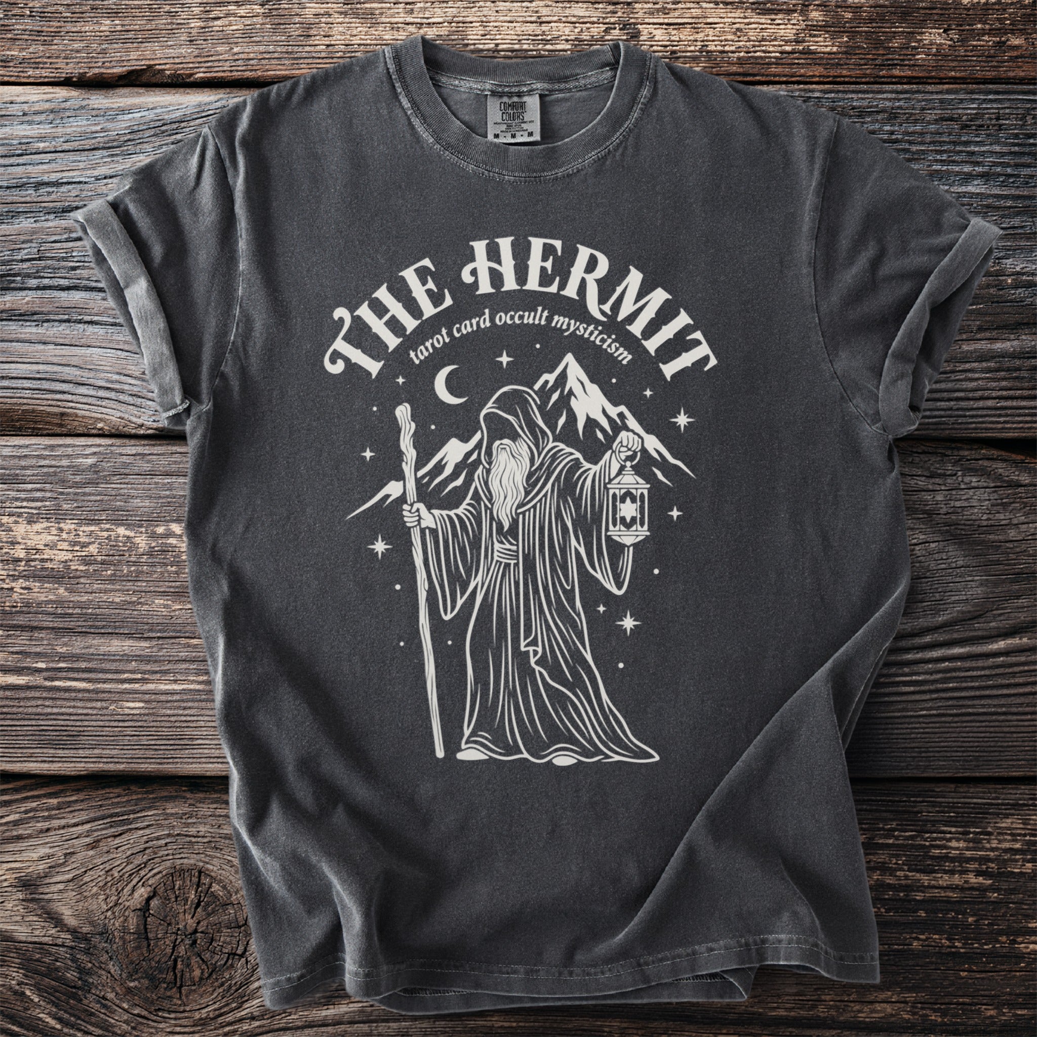 Dark gray t-shirt with a white graphic of a robed figure holding a staff and lantern.