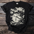 Black t-shirt with a graphic of an owl on a branch with a lantern in front of the moon.