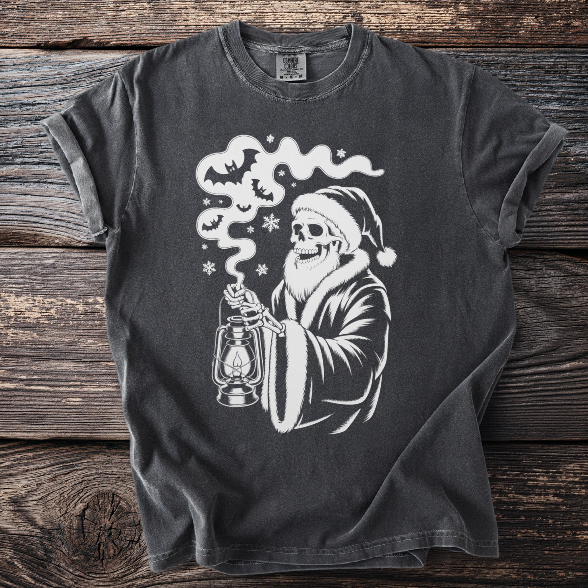 Dark gray t-shirt with a white graphic of a skeleton in a Santa hat holding a lantern.