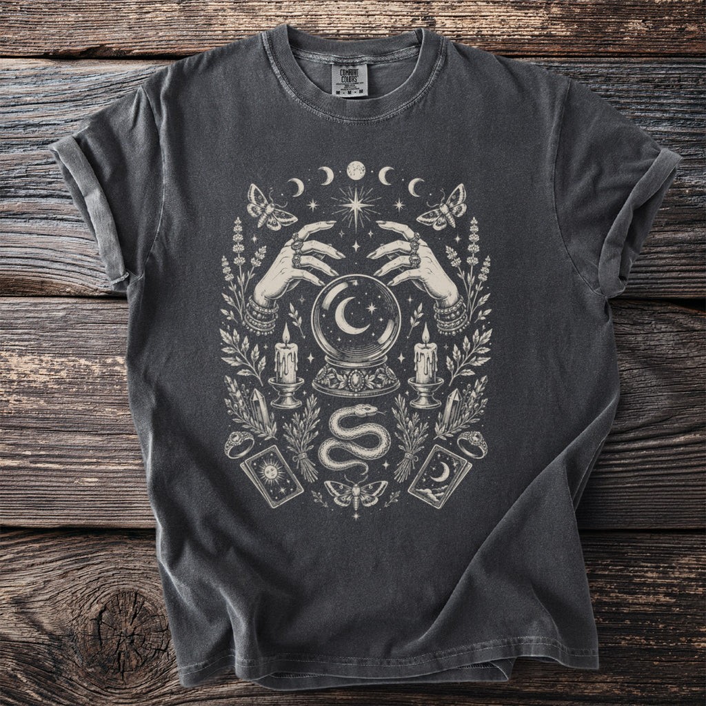 Gray t-shirt with gothic occult graphic featuring hands, crystal ball, snake, and celestial elements.
