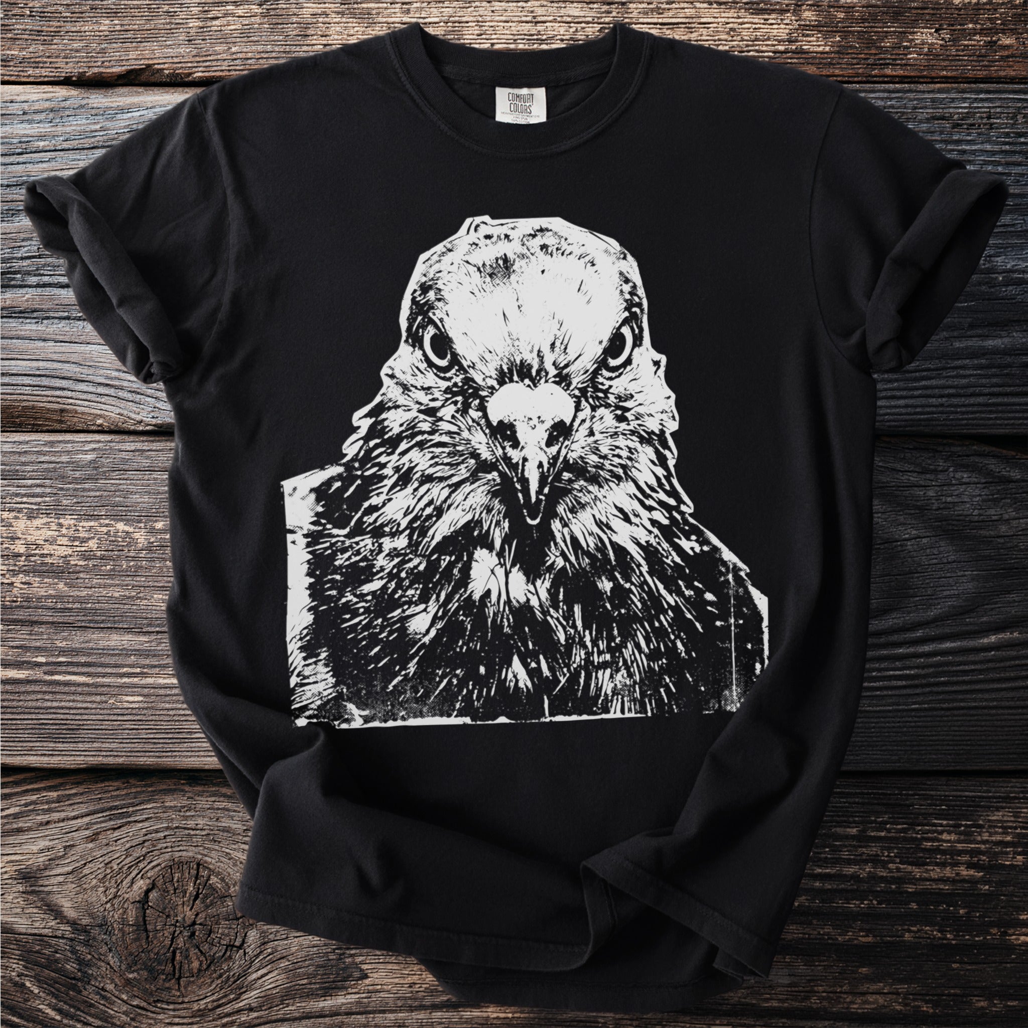 Black t-shirt with a close-up white ink sketch of a bird's head from the front.