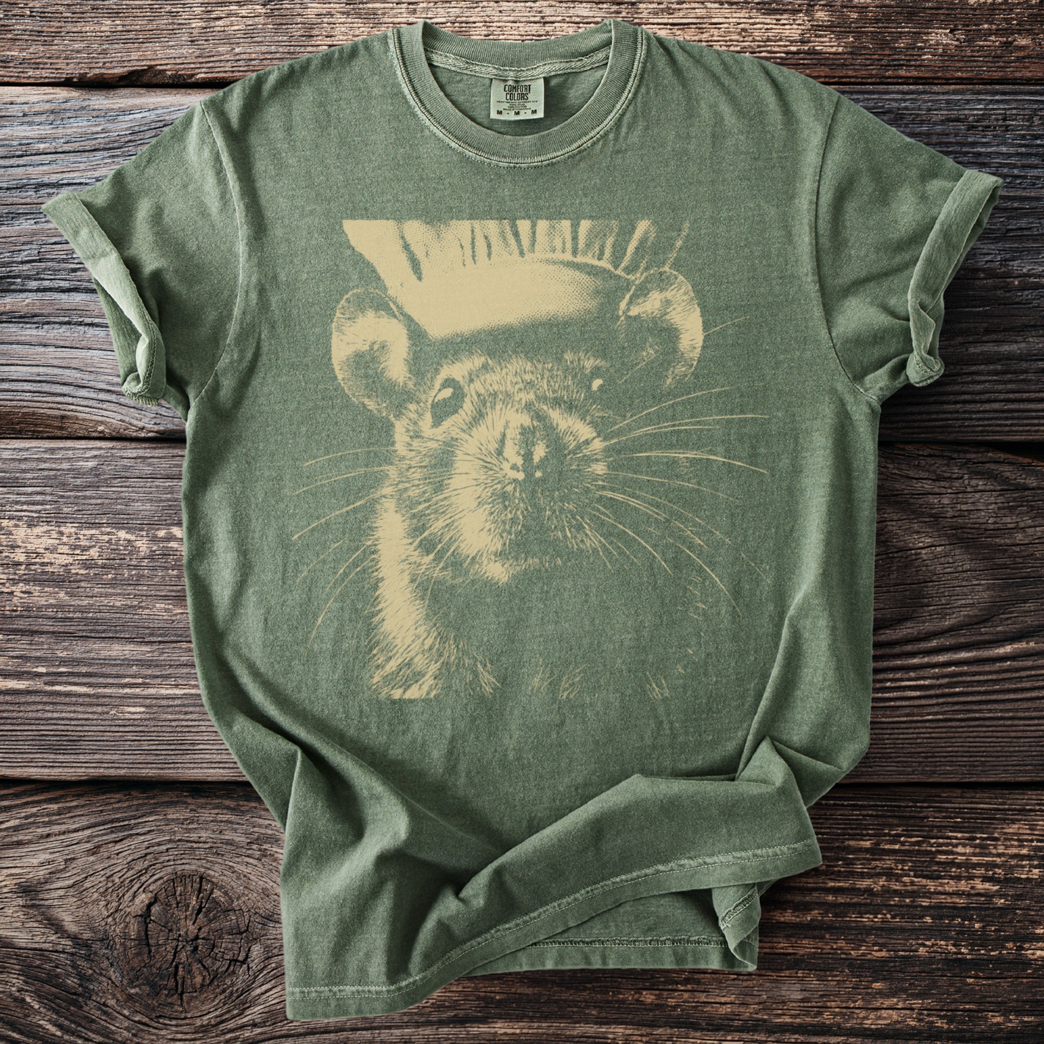 Olive green Comfort Colors t-shirt with a beige graphic of a chinchilla wearing a top hat.