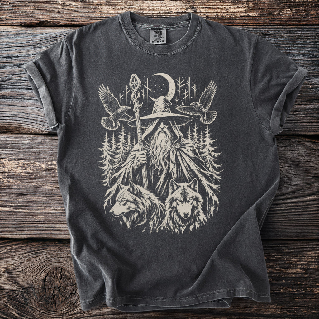 Dark grey t-shirt with a graphic of a wizard, two wolves, and two ravens in a forest.