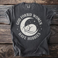 Dark t-shirt with white text and graphics of a cat on a moon.