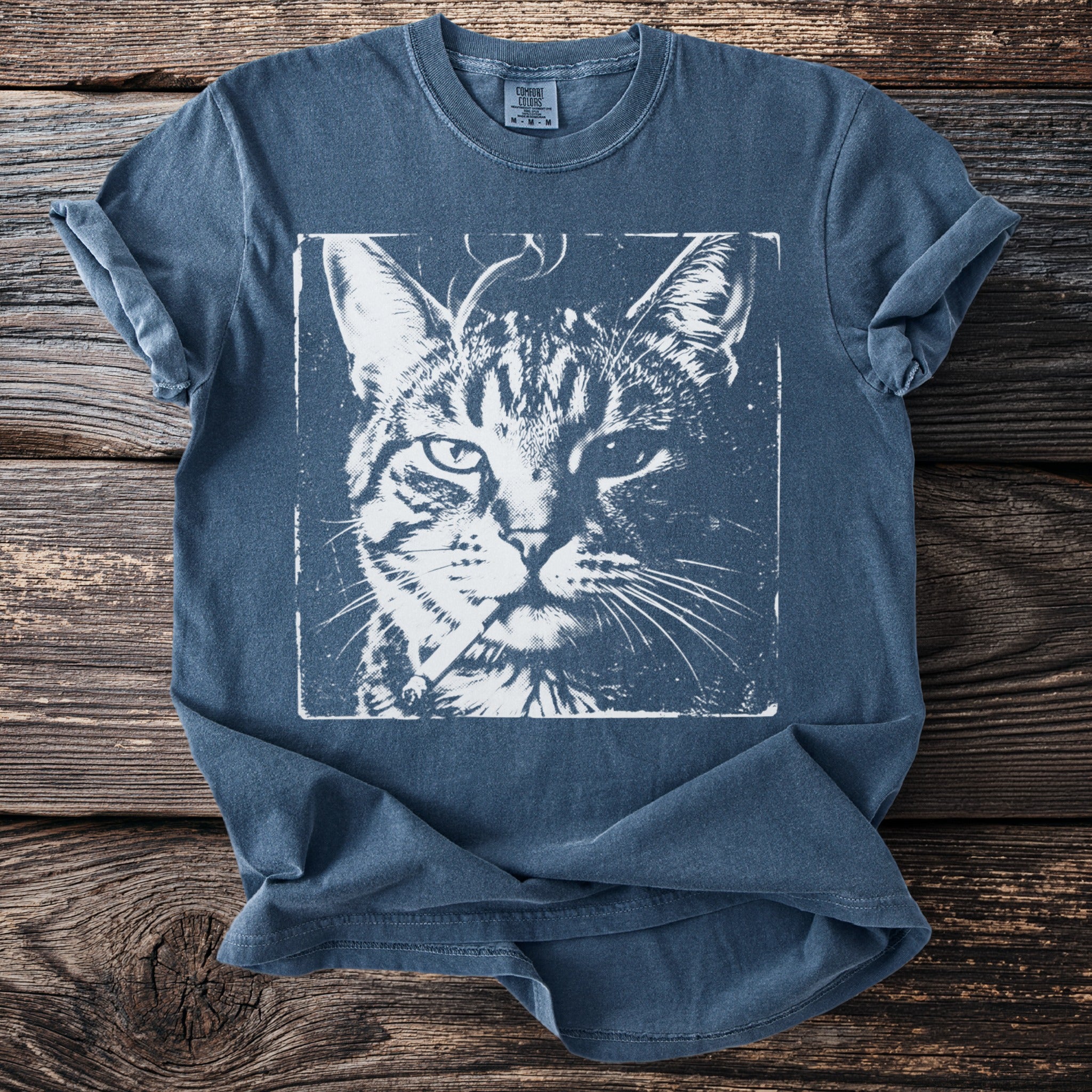 Blue t-shirt with a distressed print of a cat holding a cigarette.