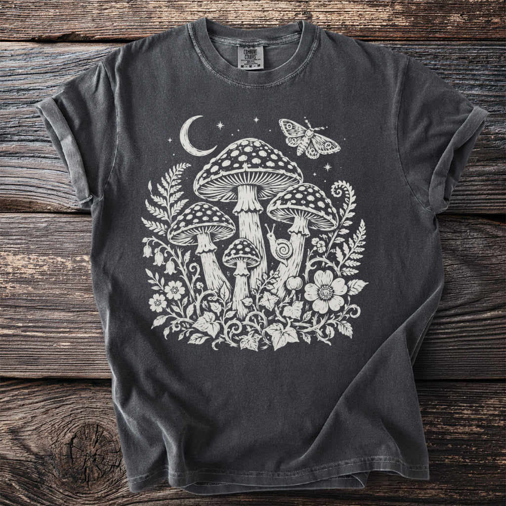 Dark t-shirt with white mushroom, moon, butterfly, and floral print.