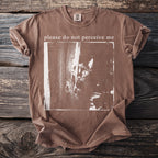 Brown t-shirt with "please do not perceive me" text and black cat graphic.