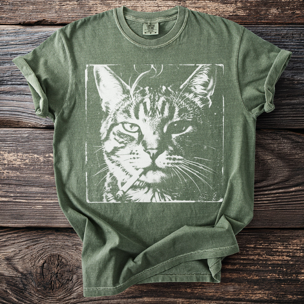 Green t-shirt with white distressed print of a tabby cat face wearing a cigarette.