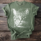 Green t-shirt with white distressed print of a tabby cat face wearing a cigarette.