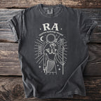Dark grey t-shirt with white line art of Egyptian sun god Ra, moon, and hieroglyphs.