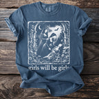 Blue t-shirt graphic with three women in dresses, roses, and a bat with text "girls will be girls."
