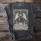 Dark t-shirt with a cream-colored mystical design featuring hands, crystal ball, snake, and candles.