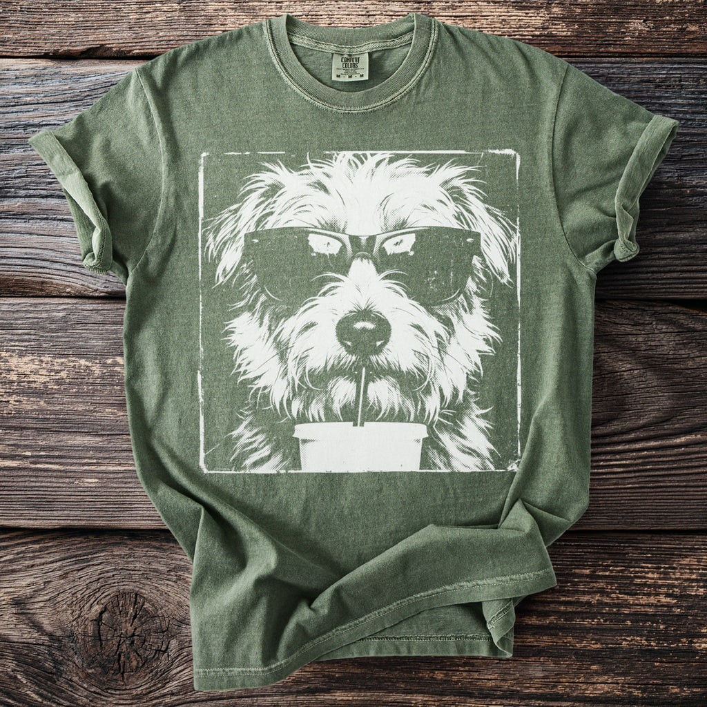 Green t-shirt with a white graphic of a shaggy dog wearing sunglasses and drinking a beverage.