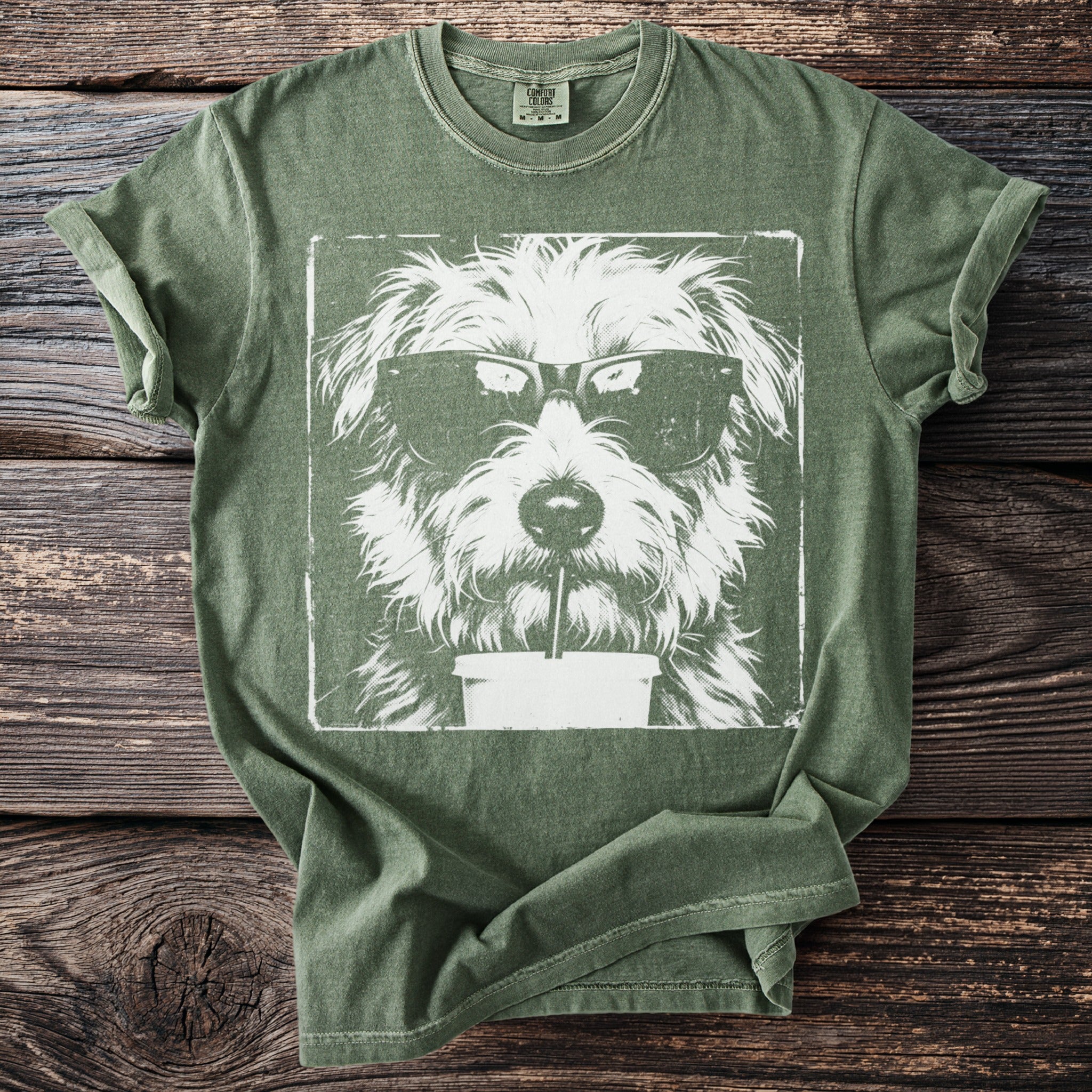 Green t-shirt with a white graphic of a shaggy dog wearing sunglasses and drinking a beverage.