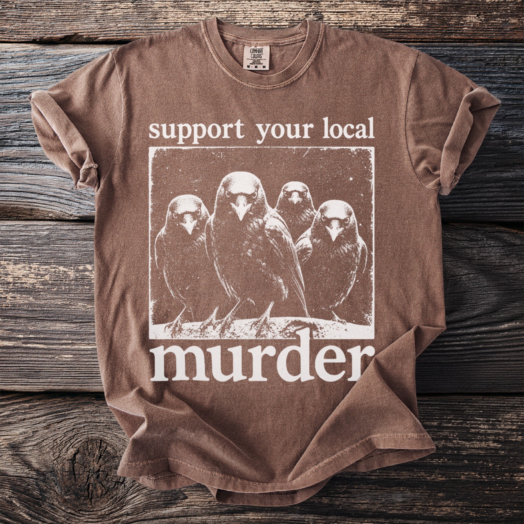 Brown t-shirt with distressed print of four crows and text "support your local murder".
